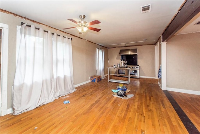 710 W Michigan St, Hammond, LA 70401 - unfurnished living room featuring wood-type flooring, a ceiling fan, and baseboards