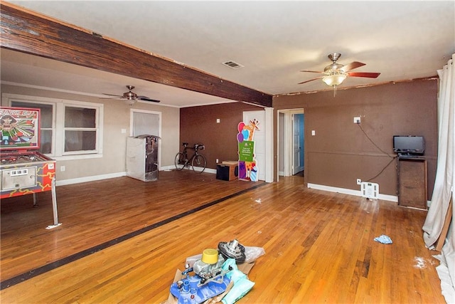 710 W Michigan St, Hammond, LA 70401 - unfurnished living room featuring a ceiling fan, wood finished floors, baseboards, and beamed ceiling