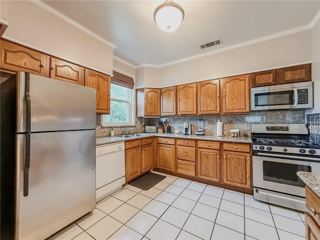 28 San Jose Ave, Jefferson, LA 70121 - kitchen with appliances with stainless steel finishes, a sink, decorative backsplash, crown molding, and light tile patterned floors