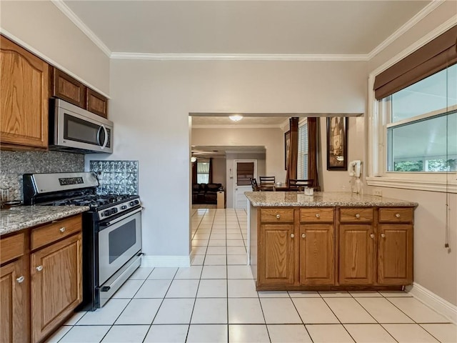 28 San Jose Ave, Jefferson, LA 70121 - kitchen with stainless steel appliances, ornamental molding, plenty of natural light, light tile patterned floors, and backsplash