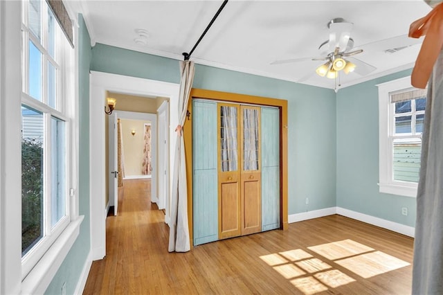 2437 Jonquil St, New Orleans, LA 70122 - unfurnished bedroom with light wood-style floors, baseboards, ornamental molding, a closet, and ceiling fan