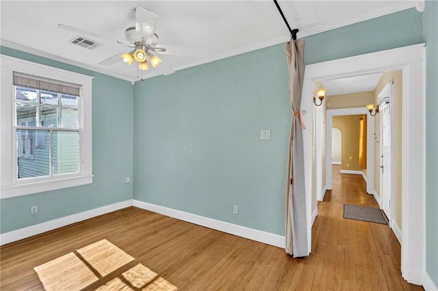 2437 Jonquil St, New Orleans, LA 70122 - unfurnished room featuring crown molding, baseboards, wood finished floors, and a ceiling fan