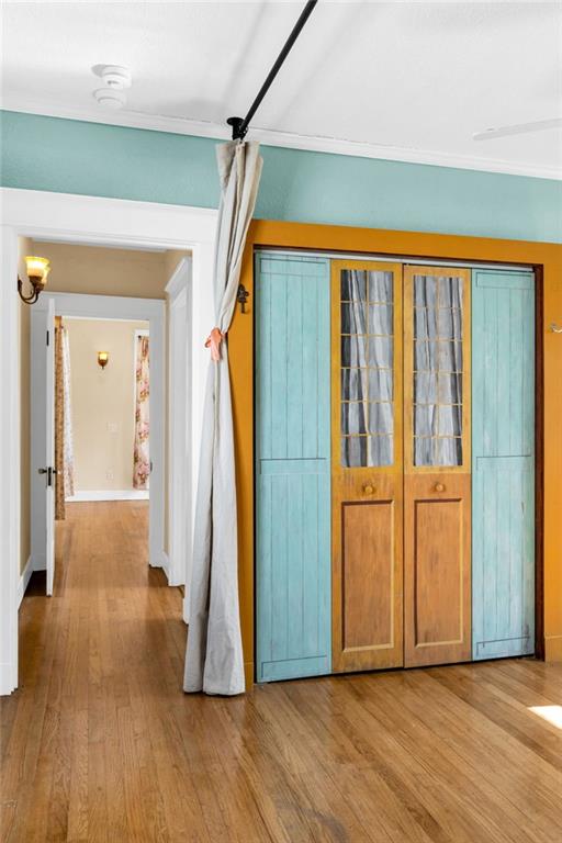 2437 Jonquil St, New Orleans, LA 70122 - corridor featuring wood finished floors and baseboards