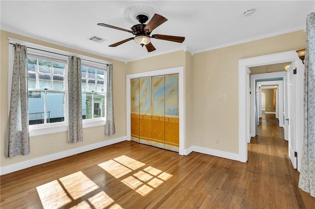 2437 Jonquil St, New Orleans, LA 70122 - unfurnished bedroom with baseboards, wood finished floors, crown molding, and ceiling fan