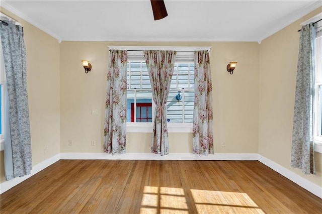 2437 Jonquil St, New Orleans, LA 70122 - spare room with wood finished floors, plenty of natural light, ceiling fan, crown molding, and baseboards