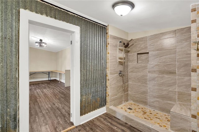 2437 Jonquil St, New Orleans, LA 70122 - bathroom with a tile shower and wood finished floors