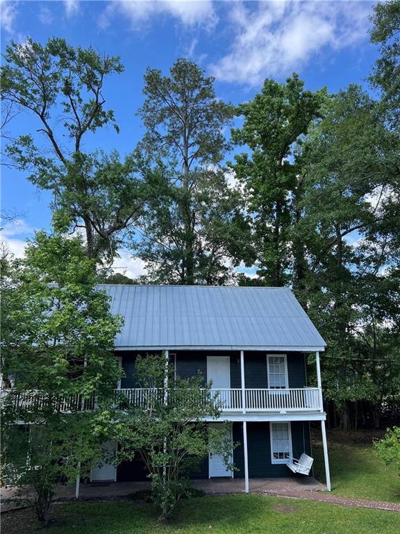 204 W 11th Ave Unit 4, Covington, LA 70433 - rear view of property with a yard, metal roof, and a patio