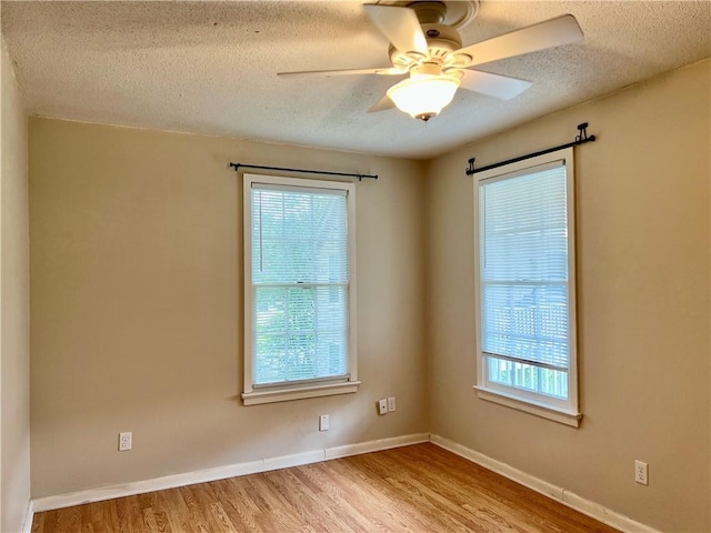 204 W 11th Ave Unit 4, Covington, LA 70433 - unfurnished room featuring a textured ceiling, wood finished floors, ceiling fan, and baseboards