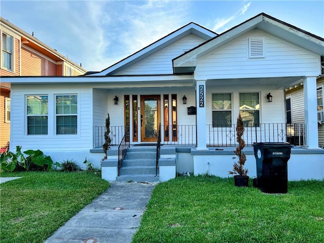 2522 Robert St, New Orleans, LA 70115 - view of front of home featuring covered porch and a front lawn