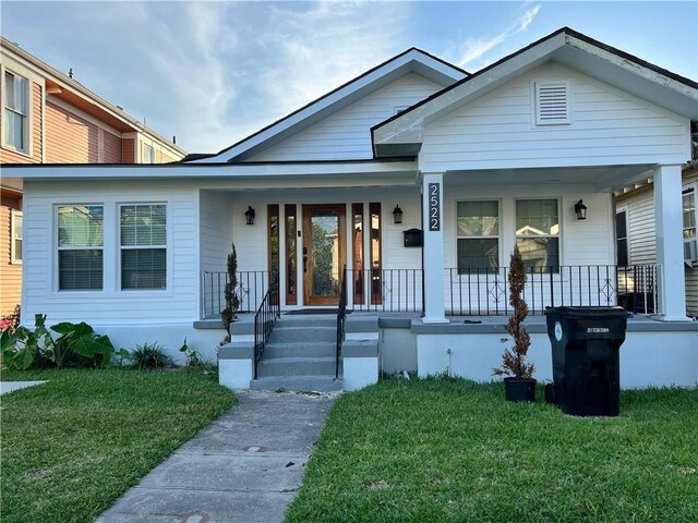 2522 Robert St, New Orleans, LA 70115 - view of front of property with covered porch and a front yard