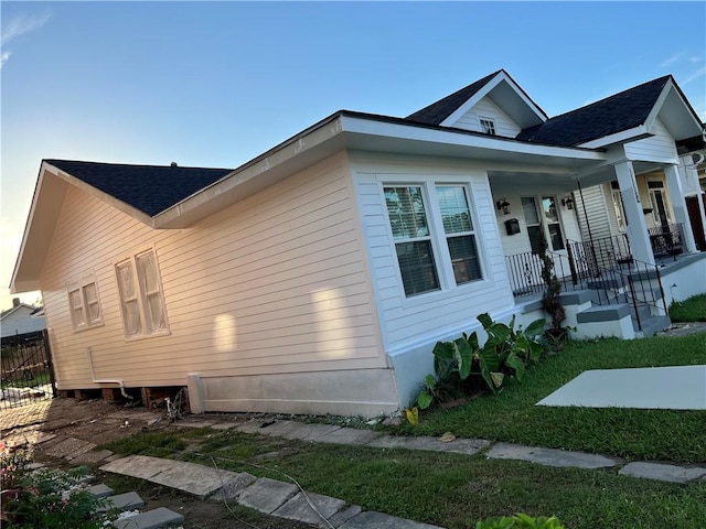 2522 Robert St, New Orleans, LA 70115 - view of home's exterior with a porch and roof with shingles