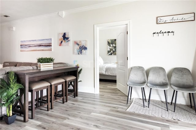2522 Robert St, New Orleans, LA 70115 - dining area featuring crown molding, wood finished floors, and baseboards