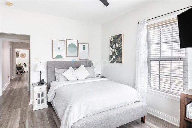 2522 Robert St, New Orleans, LA 70115 - bedroom with wood finished floors, baseboards, and a ceiling fan