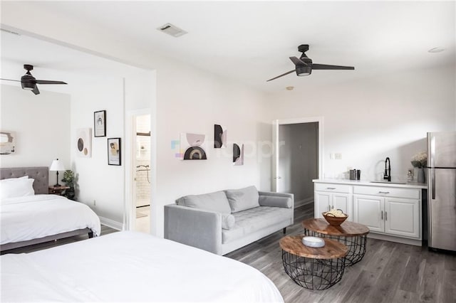2522 Robert St, New Orleans, LA 70115 - bedroom featuring a sink, freestanding refrigerator, wood finished floors, ensuite bath, and a ceiling fan