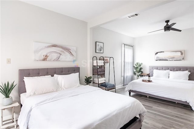 2522 Robert St, New Orleans, LA 70115 - bedroom with wood finished floors, ceiling fan, and baseboards