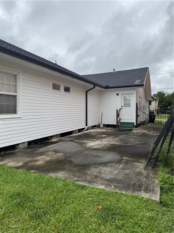 2522 Robert St, New Orleans, LA 70115 - back of property with a patio, fence, and entry steps