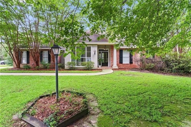 213 Secluded Oaks Ln, Madisonville, LA 70447 - view of front of property with a front lawn
