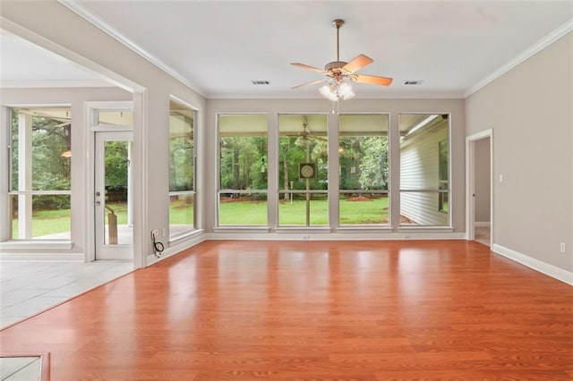 213 Secluded Oaks Ln, Madisonville, LA 70447 - unfurnished sunroom featuring crown molding, wood finished floors, and baseboards