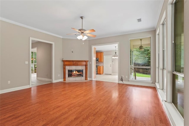 213 Secluded Oaks Ln, Madisonville, LA 70447 - unfurnished living room with healthy amount of natural light, ornamental molding, light wood-style flooring, ceiling fan, and baseboards