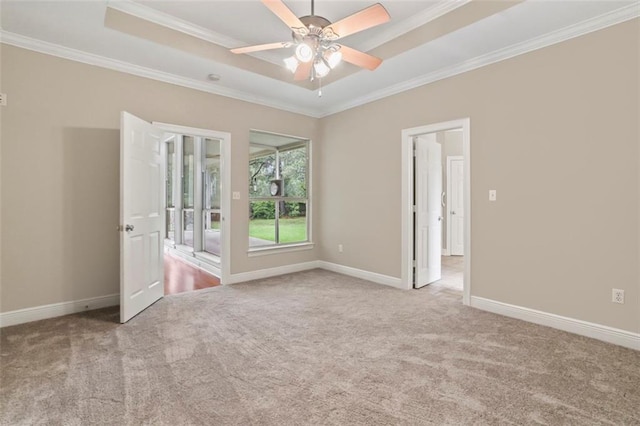 213 Secluded Oaks Ln, Madisonville, LA 70447 - empty room with ornamental molding, carpet floors, a raised ceiling, baseboards, and ceiling fan