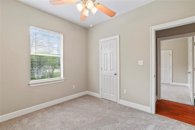 213 Secluded Oaks Ln, Madisonville, LA 70447 - unfurnished bedroom with carpet floors, baseboards, and ceiling fan