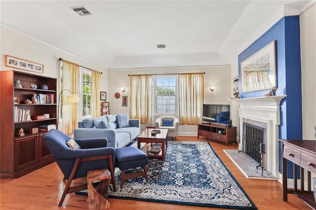 5800 Memphis St, New Orleans, LA 70124 - living room featuring healthy amount of natural light, a fireplace with flush hearth, and light wood-style floors