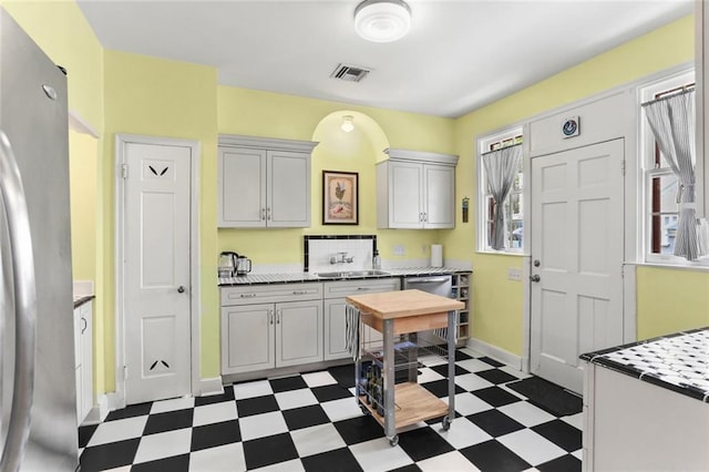 5800 Memphis St, New Orleans, LA 70124 - kitchen with stainless steel appliances, dark floors, light countertops, a sink, and baseboards
