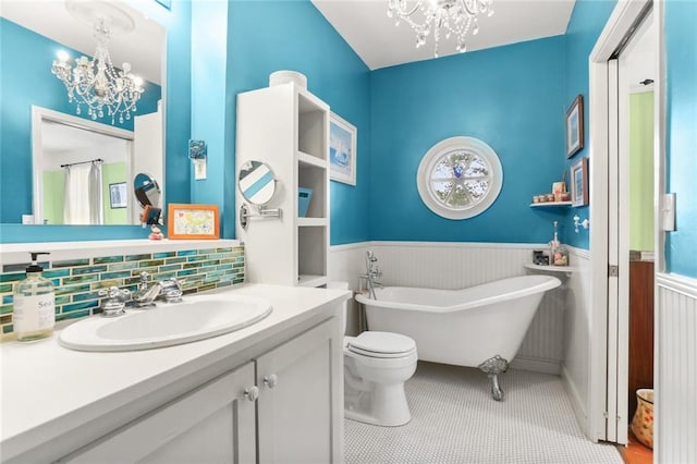 5800 Memphis St, New Orleans, LA 70124 - full bath with a chandelier, wainscoting, a soaking tub, vanity, and toilet