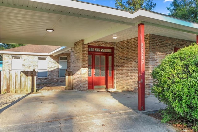 42262 Yokum Rd, Ponchatoula, LA 70454 - doorway to property with brick siding and an attached carport