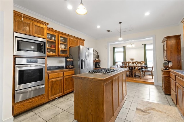 42262 Yokum Rd, Ponchatoula, LA 70454 - kitchen with appliances with stainless steel finishes, a warming drawer, brown cabinetry, dark countertops, and light tile patterned floors