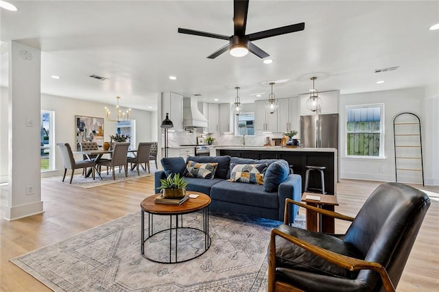 5116 Wilson Dr, Metairie, LA 70003 - living area featuring ceiling fan, light wood finished floors, baseboards, recessed lighting, and a chandelier