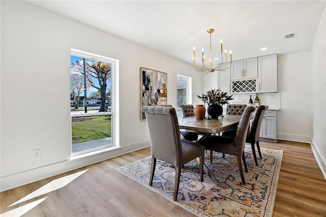 5116 Wilson Dr, Metairie, LA 70003 - dining space featuring a chandelier, light wood-type flooring, baseboards, and recessed lighting