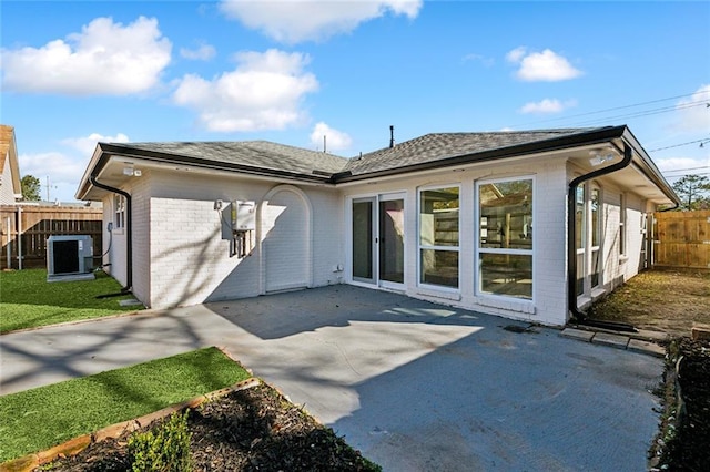 5116 Wilson Dr, Metairie, LA 70003 - rear view of property with brick siding, a patio area, and roof with shingles