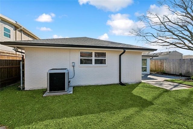 5116 Wilson Dr, Metairie, LA 70003 - rear view of property featuring brick siding, central AC unit, and roof with shingles