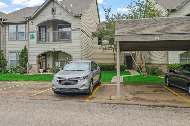350 Emerald Forest Blvd Unit 17102, Covington, LA 70433 - view of property featuring uncovered parking, roof with shingles, and a balcony