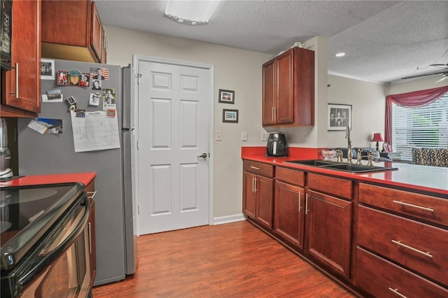 350 Emerald Forest Blvd Unit 17102, Covington, LA 70433 - kitchen with a sink, dark wood finished floors, a textured ceiling, black electric range, and reddish brown cabinets