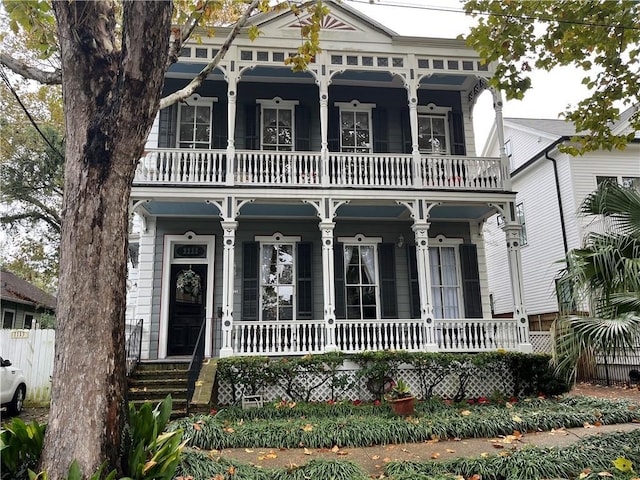 1113 Peniston St Unit A, New Orleans, LA 70115 - view of front of house featuring a balcony, covered porch, and fence
