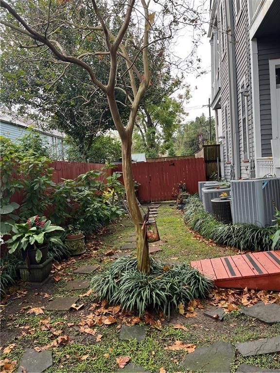 1113 Peniston St Unit A, New Orleans, LA 70115 - view of yard with fence and central AC