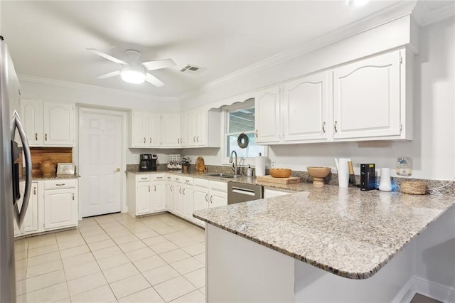 46 Begonia Dr, Covington, LA 70433 - kitchen featuring a sink, a peninsula, a ceiling fan, appliances with stainless steel finishes, and light stone counters