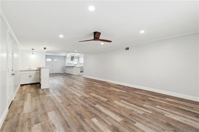 400 Sophia St, River Ridge, LA 70123 - unfurnished living room featuring ornamental molding, ceiling fan, recessed lighting, baseboards, and a sink