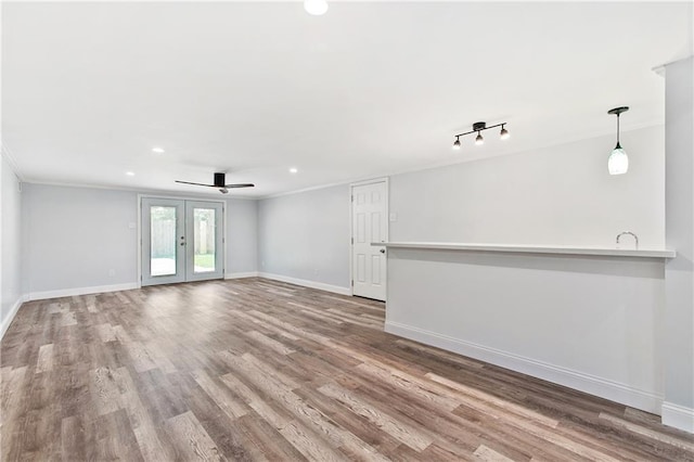400 Sophia St, River Ridge, LA 70123 - unfurnished living room featuring french doors, baseboards, wood finished floors, recessed lighting, and crown molding