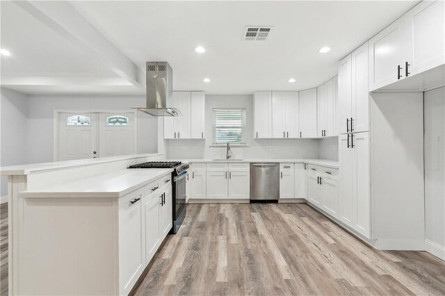 400 Sophia St, River Ridge, LA 70123 - kitchen with island range hood, appliances with stainless steel finishes, a sink, light wood-type flooring, and recessed lighting