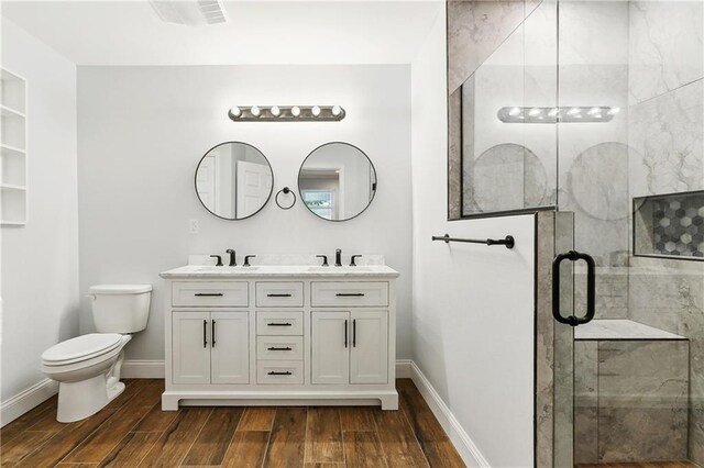 400 Sophia St, River Ridge, LA 70123 - full bathroom featuring wood finished floors, toilet, a stall shower, baseboards, and double vanity