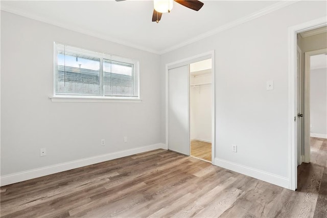 400 Sophia St, River Ridge, LA 70123 - unfurnished bedroom featuring wood finished floors, crown molding, baseboards, a closet, and ceiling fan