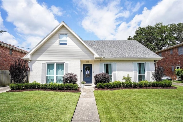 148 Macque Dr, Harahan, LA 70123 - view of front of house with a front lawn, brick siding, and roof with shingles