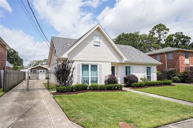148 Macque Dr, Harahan, LA 70123 - view of front facade with a gate, a shingled roof, brick siding, and driveway