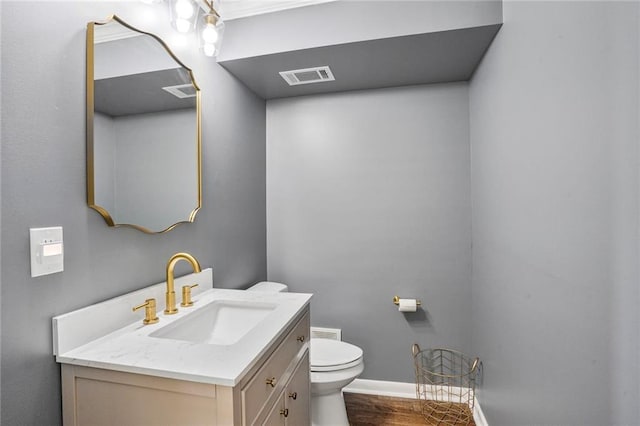 148 Macque Dr, Harahan, LA 70123 - half bath featuring toilet, vanity, baseboards, and wood finished floors