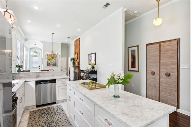 2025 First St, New Orleans, LA 70113 - kitchen with dishwasher, crown molding, light wood finished floors, white cabinetry, and a kitchen island