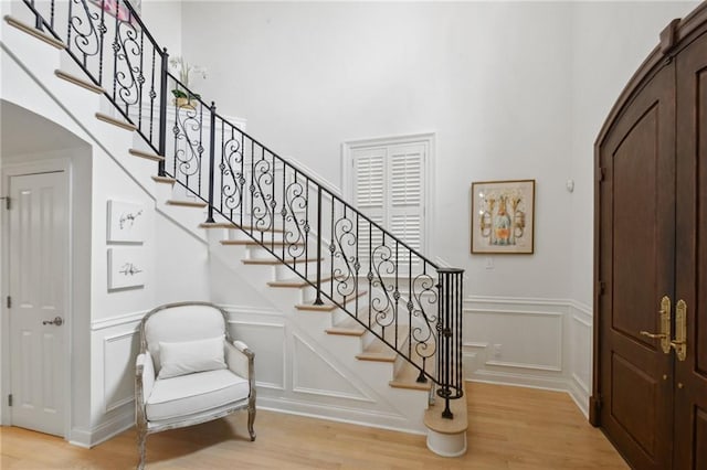 3117 39th St, Metairie, LA 70001 - staircase with a decorative wall, wood finished floors, and wainscoting