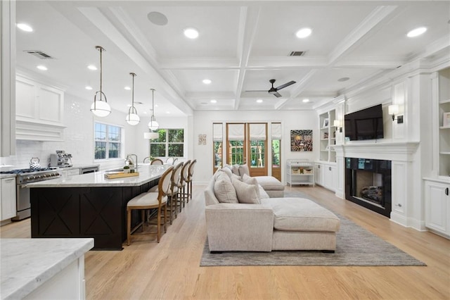 3117 39th St, Metairie, LA 70001 - living room with ceiling fan, light wood-style floors, a fireplace, beamed ceiling, and coffered ceiling